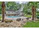 Lush backyard oasis showcasing a sparkling pool, mature palm trees, and well-manicured landscaping at 522 Golfview Dr, Peachtree City, GA 30269