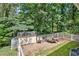Backyard shed and trailer, offering functional space for storage, set within a fenced-in area for added privacy at 522 Golfview Dr, Peachtree City, GA 30269