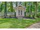 Backyard shed featuring a charming design and well-manicured landscaping, perfect for storage or a hobby space at 522 Golfview Dr, Peachtree City, GA 30269