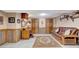 Finished basement area with desk, futon, wood-look wall paneling, and convenient storage at 522 Golfview Dr, Peachtree City, GA 30269