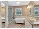 Elegant bathroom with a soaking tub, tiled shower and wood look herringbone floor at 522 Golfview Dr, Peachtree City, GA 30269