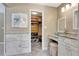Bathroom features a vanity and makeup counter and a peek into a walk-in closet at 522 Golfview Dr, Peachtree City, GA 30269