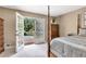 Bedroom with a four poster bed and french doors leading to a deck with pool at 522 Golfview Dr, Peachtree City, GA 30269