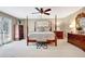 Large bedroom featuring a four-poster bed, and a bench seat at 522 Golfview Dr, Peachtree City, GA 30269