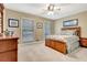 Comfortable bedroom with neutral colors, ceiling fan, and large windows at 522 Golfview Dr, Peachtree City, GA 30269