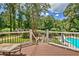 Deck overlooks a pool and beautifully landscaped backyard, creating a serene outdoor oasis at 522 Golfview Dr, Peachtree City, GA 30269