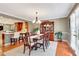 Dining room with wood floors, chandelier, and view into kitchen with stone countertops at 522 Golfview Dr, Peachtree City, GA 30269