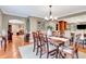 Elegant dining room with hardwood floors, chandelier, and view into other rooms at 522 Golfview Dr, Peachtree City, GA 30269