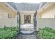 Inviting entryway courtyard with a wrought iron gate leading to the front door and charming decor at 522 Golfview Dr, Peachtree City, GA 30269