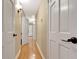 Hallway with wood floors, white doors, and wall sconces at 522 Golfview Dr, Peachtree City, GA 30269