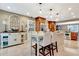 Well-lit kitchen with island, white cabinetry, pendant lights and stainless steel appliances at 522 Golfview Dr, Peachtree City, GA 30269