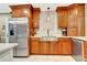Kitchen featuring stainless appliances and light stone countertops with wooden cabinets at 522 Golfview Dr, Peachtree City, GA 30269