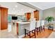 Open kitchen with white counter seating, stylish cabinets, and wood floors at 522 Golfview Dr, Peachtree City, GA 30269