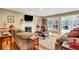 Bright living room with fireplace, hardwood floors, and french doors to the porch at 522 Golfview Dr, Peachtree City, GA 30269