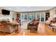 Comfortable living room featuring hardwood floors, french doors to the porch, and a fireplace at 522 Golfview Dr, Peachtree City, GA 30269