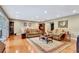 Open living room with hardwood floors, bright recessed lighting, and comfortable couches at 522 Golfview Dr, Peachtree City, GA 30269