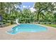 Inviting in-ground pool with a slide, surrounded by a spacious patio and meticulously maintained landscaping at 522 Golfview Dr, Peachtree City, GA 30269