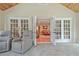 Bright sunroom with wood ceiling, tile floors, and french doors to the living room at 522 Golfview Dr, Peachtree City, GA 30269