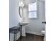 Bright bathroom featuring a pedestal sink, oval mirror and a window letting in lots of natural light at 5512 Cascade Run, Atlanta, GA 30336