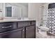 Bathroom featuring a vanity with black cabinets, shower with patterned curtain and toilet at 5512 Cascade Run, Atlanta, GA 30336