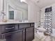 Modern bathroom features a single sink vanity and a shower-tub combo with stylish shower curtain at 5512 Cascade Run, Atlanta, GA 30336