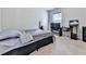 A spacious bedroom is carpeted and has a bed, a desk, a TV and a standing mirror at 5512 Cascade Run, Atlanta, GA 30336
