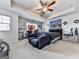 Cozy bedroom showcasing a tray ceiling with fan, complemented by neutral tones and comfortable furnishings at 5512 Cascade Run, Atlanta, GA 30336