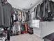 Walk-in closet with custom shelving, hanging rods, and window, providing ample storage space at 5512 Cascade Run, Atlanta, GA 30336