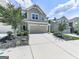 Inviting two-story home features a gray exterior, attached two-car garage, and well-maintained landscaping at 5512 Cascade Run, Atlanta, GA 30336