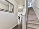 Hallway with stairway and modern mirror in neutral colors, showing the way to a bright living room at 5512 Cascade Run, Atlanta, GA 30336