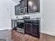 Modern kitchen appliances include stainless steel oven, microwave, and dark wood cabinets at 5512 Cascade Run, Atlanta, GA 30336