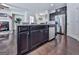 Modern kitchen featuring a dark island with granite countertop, stainless steel appliances, and hardwood flooring at 5512 Cascade Run, Atlanta, GA 30336