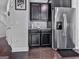 Well-equipped kitchen with stainless steel refrigerator and ample dark wood cabinetry at 5512 Cascade Run, Atlanta, GA 30336