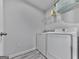 Efficient laundry area with modern washer and dryer, plus shelving for storage at 5512 Cascade Run, Atlanta, GA 30336