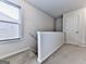 Bright stairwell features a large window, carpeted steps and white trim at 5512 Cascade Run, Atlanta, GA 30336