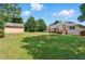 Expansive backyard with lush lawn, patio, and storage shed at 75 Fox Chase, Covington, GA 30016