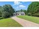 Charming single-story home with a well-manicured front lawn and long driveway at 75 Fox Chase, Covington, GA 30016