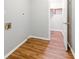 Practical laundry room with laminate flooring, access to closet, and connections for washer and dryer at 75 Fox Chase, Covington, GA 30016