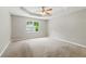Spacious main bedroom featuring a tray ceiling and large window for lots of natural light at 75 Fox Chase, Covington, GA 30016