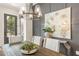 Elegant dining room features a stylish light fixture, and a statement wall with paneling and artwork at 937 Willingham Dr # 7, Hapeville, GA 30354