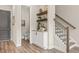 Hallway with stairs and powder room with floating shelves create stylish storage at 937 Willingham Dr # 7, Hapeville, GA 30354