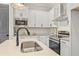 Bright and modern kitchen featuring white cabinets, stainless steel appliances, and an island sink at 937 Willingham Dr # 7, Hapeville, GA 30354