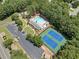 Aerial view of community pool, clubhouse, tennis courts, playground, and parking at 2019 Aldbury Ln, Woodstock, GA 30189