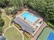 Community pool, clubhouse, parking, and tennis courts from an aerial view at 2019 Aldbury Ln, Woodstock, GA 30189