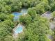 An aerial view of the community with pools and tennis courts surrounded by lush trees and greenery at 2019 Aldbury Ln, Woodstock, GA 30189