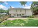 The back exterior features a patio area, well-maintained lawn, and lush landscaping at 2019 Aldbury Ln, Woodstock, GA 30189
