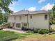 Two-story home with a well-manicured lawn, patio, and mature landscaping at 2019 Aldbury Ln, Woodstock, GA 30189