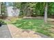 A charming backyard featuring a well-maintained lawn and a stylish stone patio, perfect for outdoor relaxation at 2019 Aldbury Ln, Woodstock, GA 30189