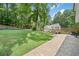 Backyard view showcasing a patio, lush lawn, and beautifully landscaped garden at 2019 Aldbury Ln, Woodstock, GA 30189