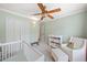This Bedroom offers ample storage with a crib, changing station, and chair at 2019 Aldbury Ln, Woodstock, GA 30189